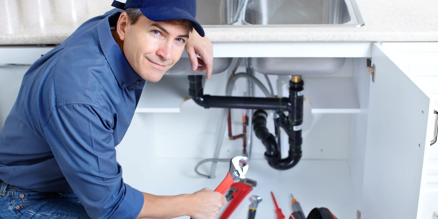 a plumber technician with a tool belt from Quality Plumber Leander in Leander, TX - Garbage Disposal Repair