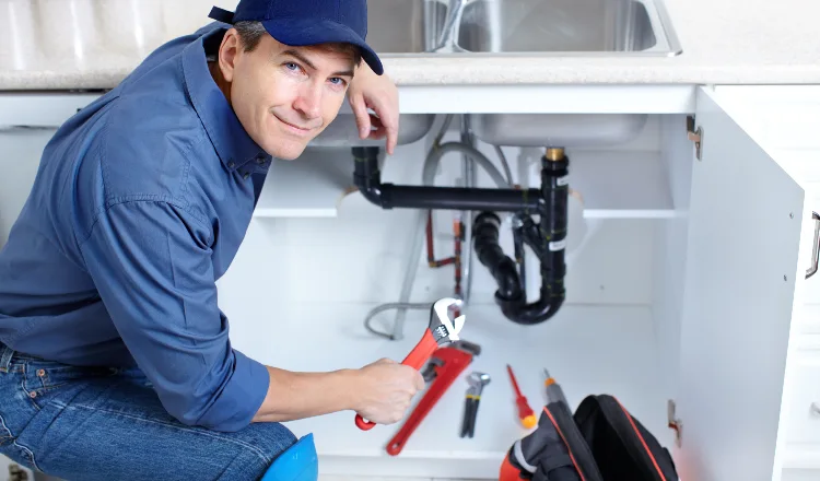 a plumber technician with a tool belt from Quality Plumber Leander in Leander, TX - Garbage Disposal Repair