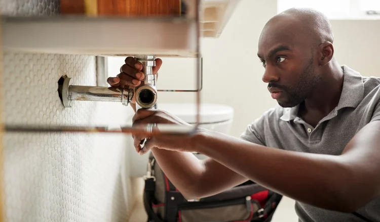 a male plumber fixing a pipe connection from Quality Plumber Leander in Leander, TX Plumber near me